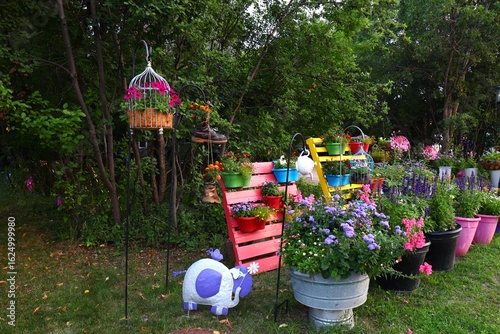 Obraz na plátně Colorful Flower Pots and Hanging Baskets Along a Street
