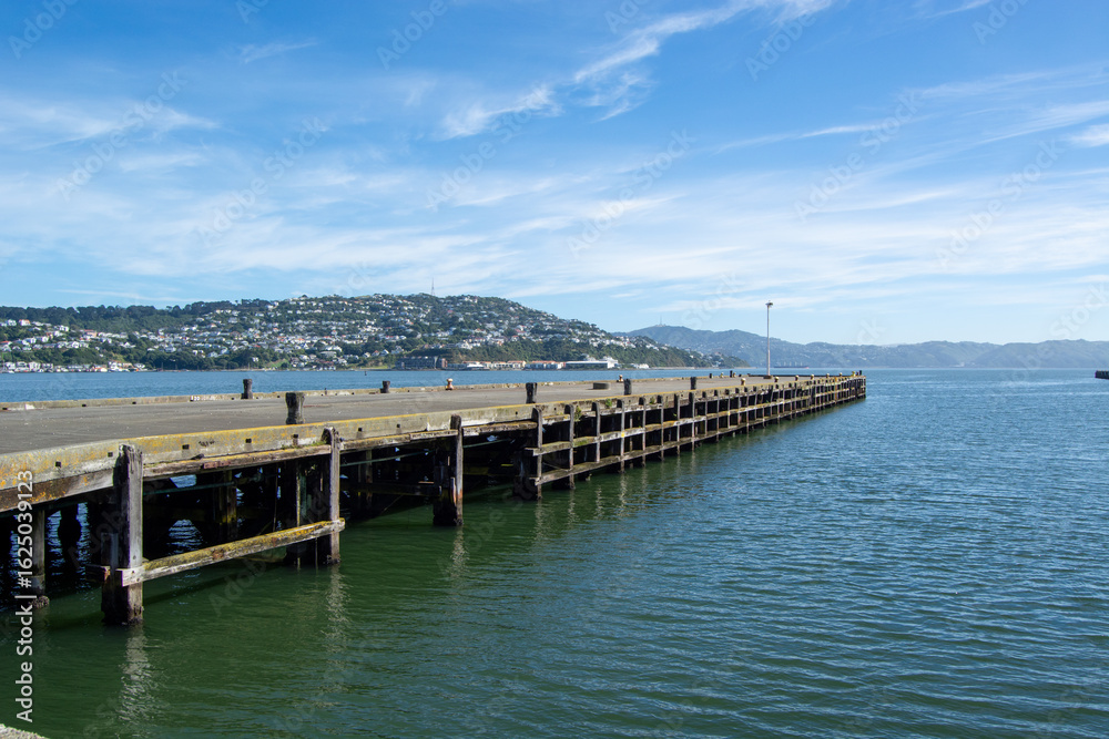 Obraz premium Serene Wooden Pier Over Calm Waters