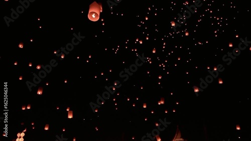 Many floating lanterns are released into the night sky in thailand