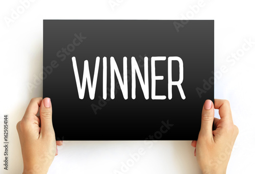 Winner - individual or team who emerges victorious or achieves success in a competition or challenge, text concept on card