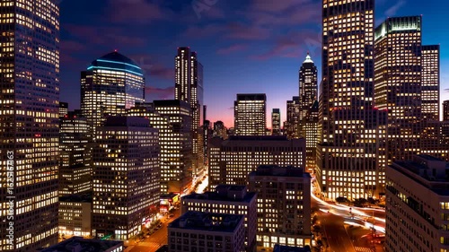 Night Cityscape of Skyscrapers Illuminated by City Lights in Urban Environment with Dusk Sky Overhead