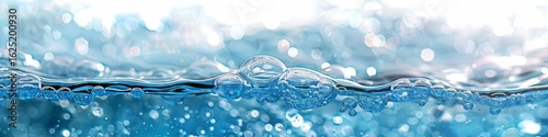 Vibrant blue water with sparkling bubbles on the surface. A panoramic view representing freshness and clean energy.