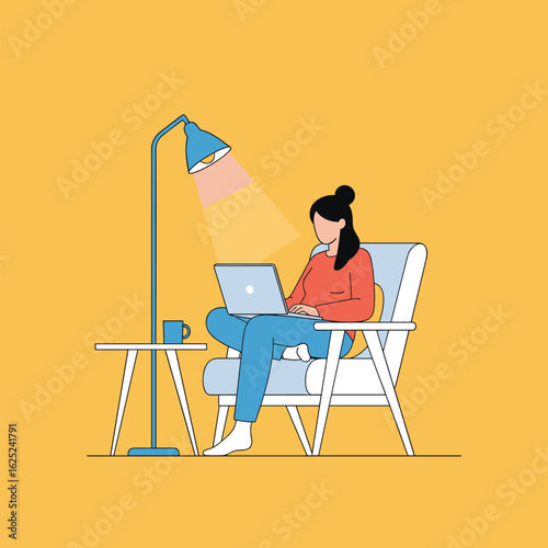 Focused professional working remotely on a laptop in a comfortable armchair under a floor lamp