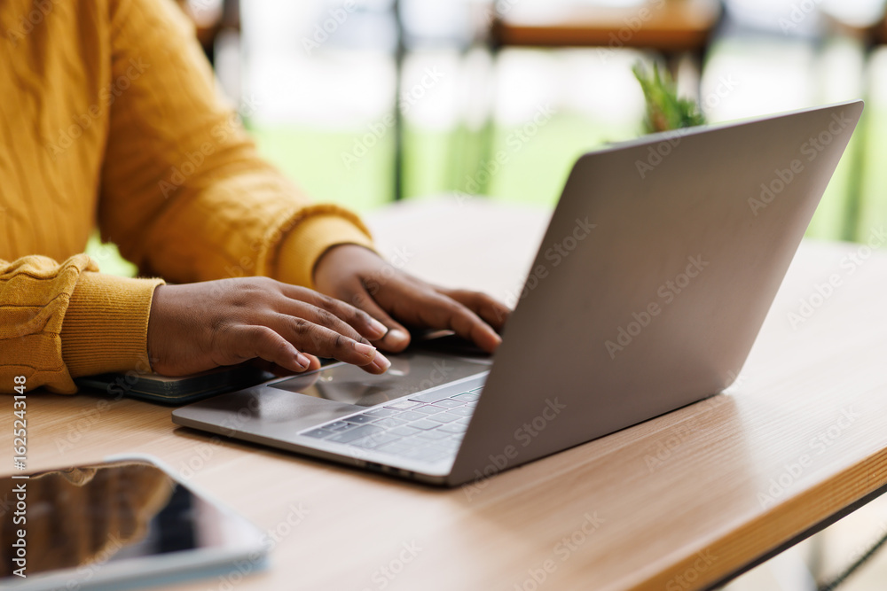 Fototapeta premium African american woman hand typing on laptop computer keyboard. Business woman online working on laptop computer, 