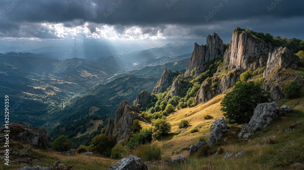 Obraz premium Dramatic cliffs and rocky outcrops under a stormy sky scenic mountain landscape with rays of sunlight breaking through the clouds