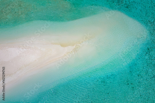 Εκτύπωση καμβά Tranquil aerial view of tropical sandbar with soft sandy shore, calming waves and clear sea lagoon