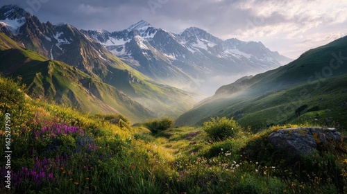 Majestic snow-capped mountains under a golden sunrise scenic alpine landscape with misty valleys and vibrant wildflowers