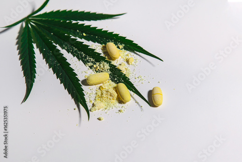 large medical cannabis with yellow stitch and medicine on a light background