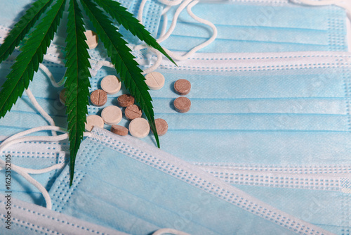 Medical cannabis letter and pills on background with medical, blue masks