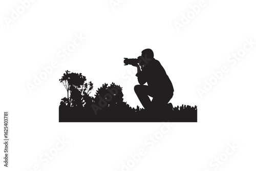 Silhouette of a photographer crouching in a field of grass and foliage aiming their camera to capture a moment in nature