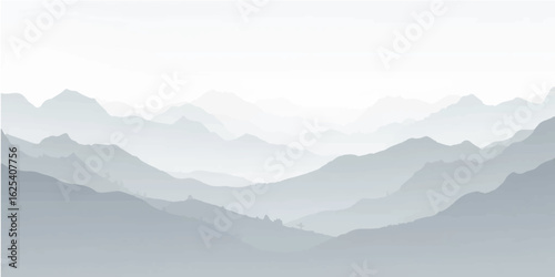 Misty mountain peaks with a cloudy landscape at sunrise