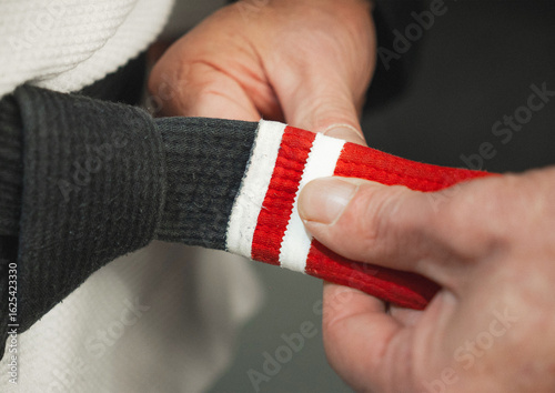 jiu jitsu teacher graduating his student to second degree black belt
