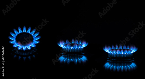 Dynamic blue gas flames dance on a dark reflective surface, showcasing modern stove burner efficiency and clean energy