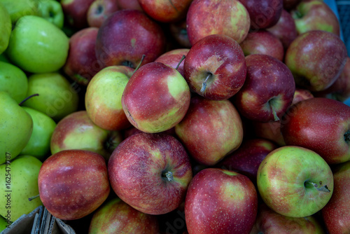 Many ripe red, green apples. Sale of apples at the market and store. Background. Top view. Concept sale at the market and store. Farm products.