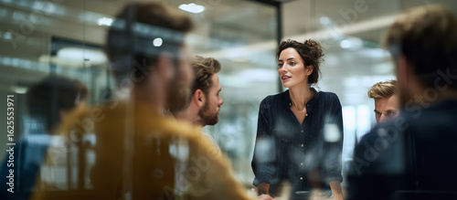 Diverse Team Brainstorming in Modern Office* — Professional multiethnic colleagues discussing IT strategy at a business meeting. Real-life corporate teamwork and innovation concept.
