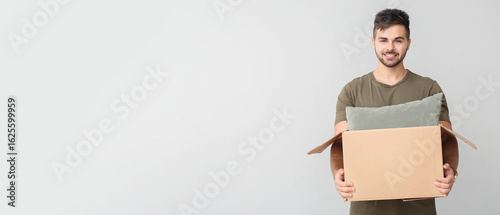 Young man with parcel on li...