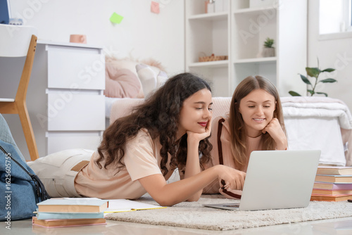 Female students using lapto...