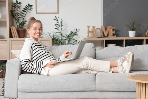 Young woman using modern la...