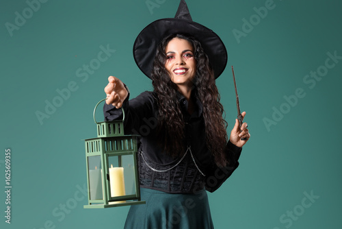 Young witch with wand and l...