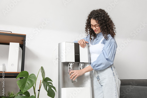 Beautiful woman pouring wat...