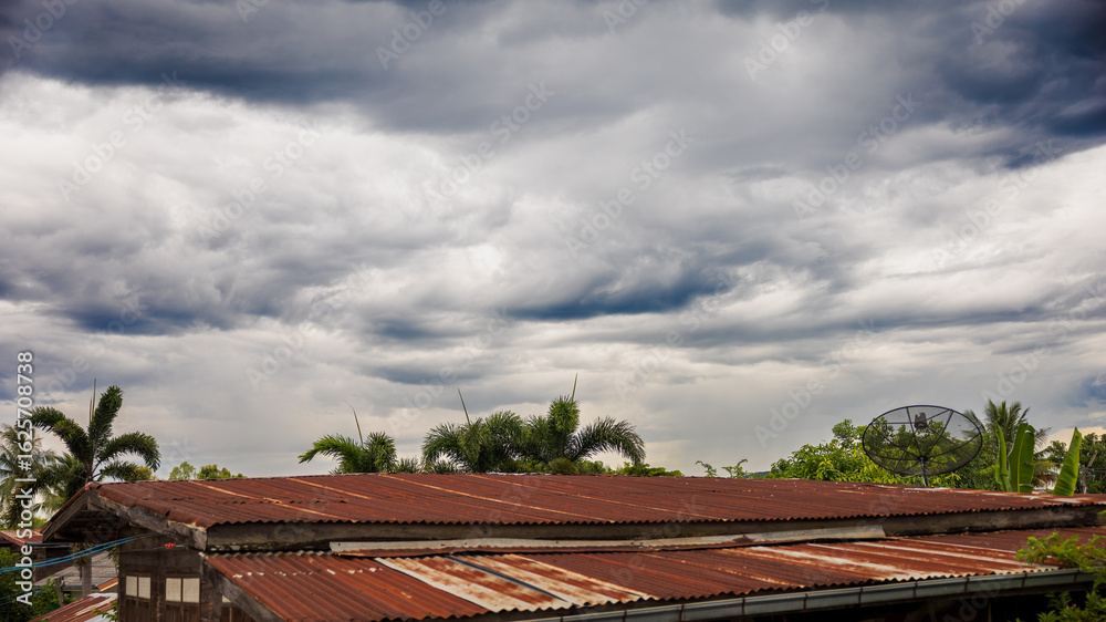Cloudy sky over countryside rooftops Cloudy sky over countryside rooftops