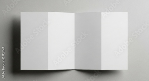 A pristine white paper brochure, unfolded to reveal four panels, lies flat on a neutral background, providing a clean and versatile template