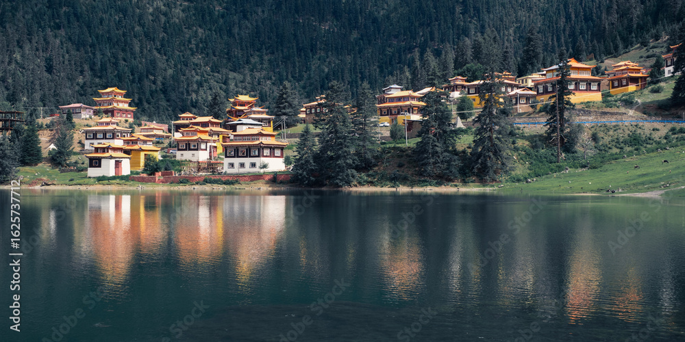 Fototapeta premium Beautiful Tibetan Buddhism Temple by the shore of Cuoka Lake, Sichuan, China