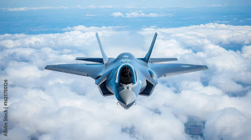 Fototapeta premium Advanced Fighter Jet Flying Above Clouds in Clear Blue Sky
