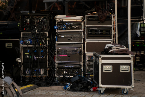Foto Professional audio equipment racks and flight cases backstage at live event, tec