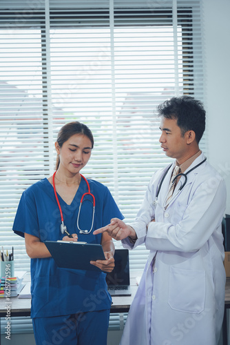 Medical professionals collaborating: A doctor and nurse are immersed in a discussion within a well-lit office, highlighting medical teamwork and patient-centered care.