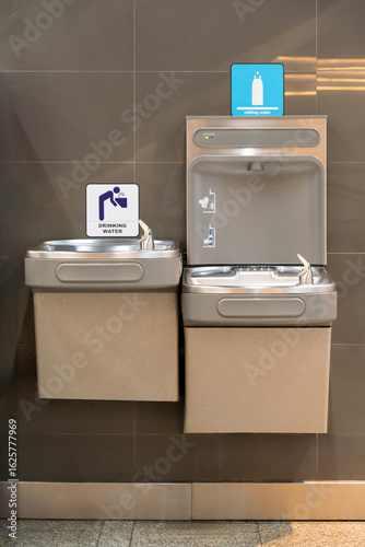 This is a public drinking water station that includes  two drinking fountains and a bottle filling station in public space.