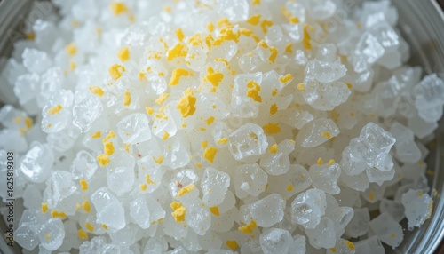 Close up of white rock candy crystals with yellow sugar sprinkles image