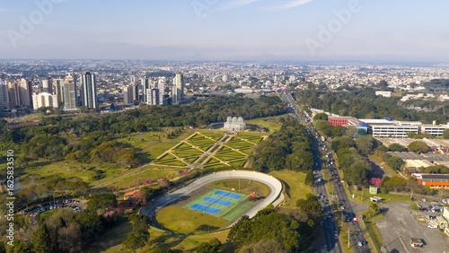 Aerial view of Curitiba's Botanical Garden and city skyline on a clear day.