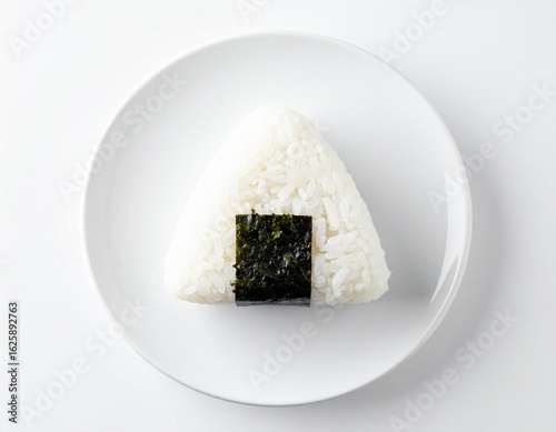 Minimalist Japanese onigiri rice ball on white plate, top view, clean background