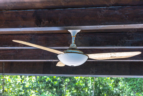 Rustic Ceiling Fan with Wooden Blades on Wooden Patio Ceiling