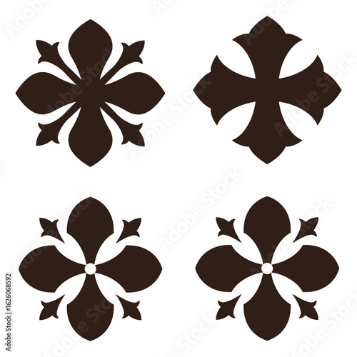 Four dark ornate decorative cross shapes with petal like accents on a white background