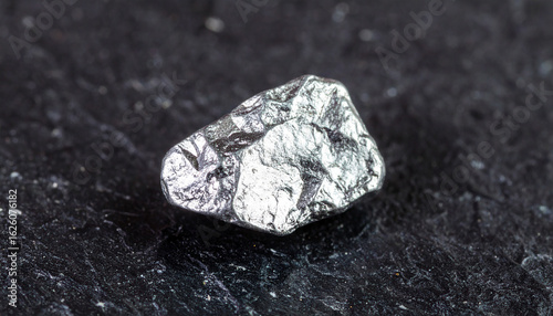 Platinum Nugget's: Captivating a platinum nugget, presented in detailed and high-quality image, its natural and unadulterated form as a valuable mineral is highlighted against a dark surface.