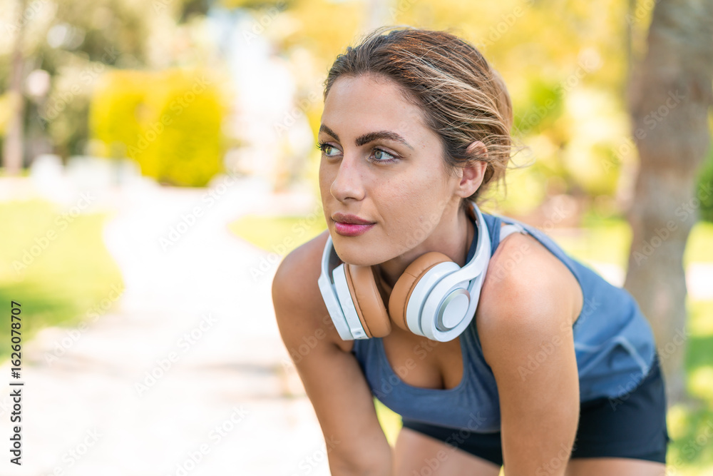 Fototapeta premium Young blonde woman at outdoors wearing sport wear