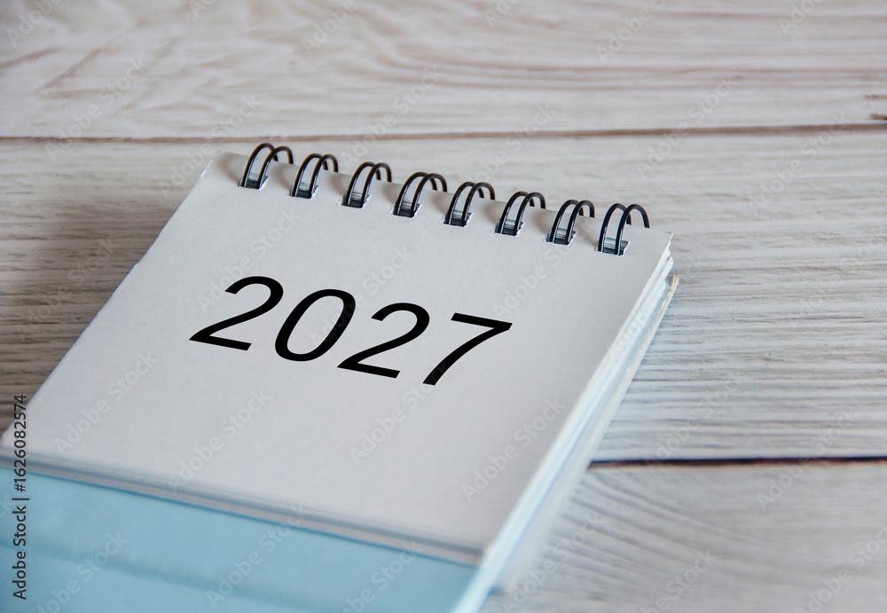 Close up of 2027 calendar on wooden background Close up of 2027 calendar on wooden background