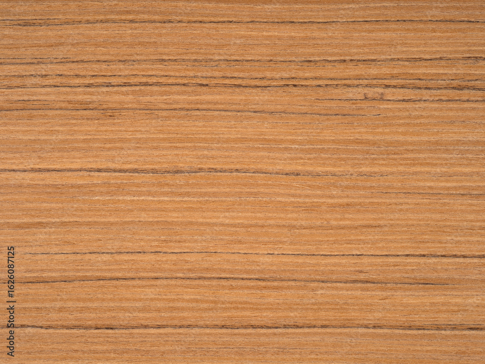 Fototapeta premium Teak wood veneer surface with warm golden hues interlaced with rich brown grain lines