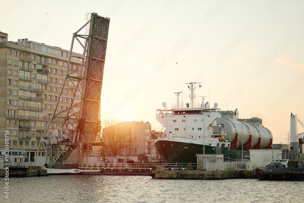 Fototapeta premium LNG Tanks Transportation On Deck Of Heavy-Lift Vessel, Heavy Load Carrier Entering The Basin Through The Lock