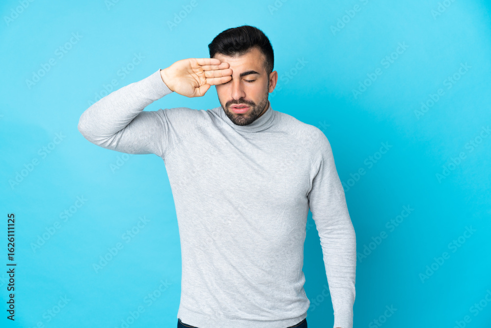 Caucasian man over isolated blue background with tired and sick expression Caucasian man over isolated blue background with tired and sick expression