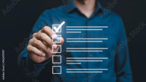 Person in Blue Shirt Checking a Digital Checklist on Dark Background