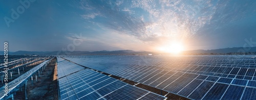 Vast solar panel field under a vibrant sunset