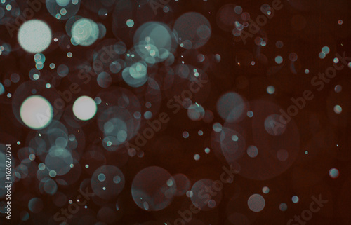 Teal Bokeh Light Particles on Dark Abstract Background