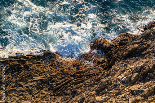 Fototapeta Naklejka Na Ścianę i Meble -  A photo of a bird sitting on a rock by the ocean
