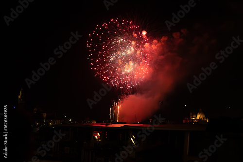A photo of a fireworks is lit up the night sky