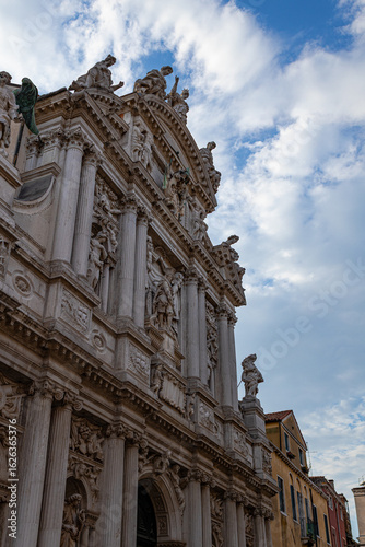 A photo of a building with statues on the side of it