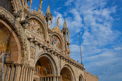 A photo of a large building with a clock on the side