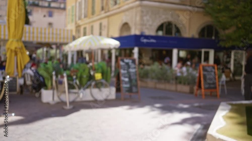 Wallpaper Mural Blurry scene of a street cafe in marseille with people dining under umbrellas surrounded by defocused bicycles and decor. Torontodigital.ca